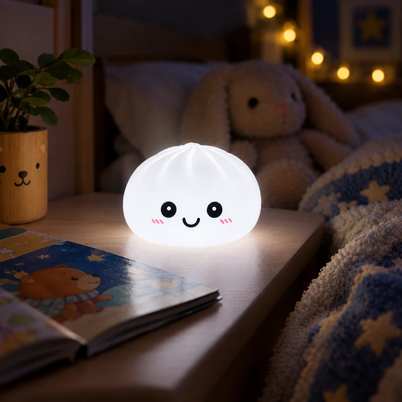White Dumpling night light glowing on a bedside table